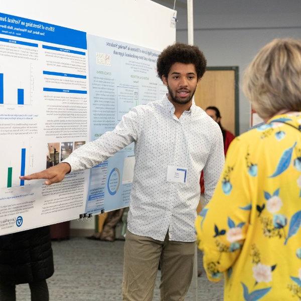 Student discusses his research with a faculty member